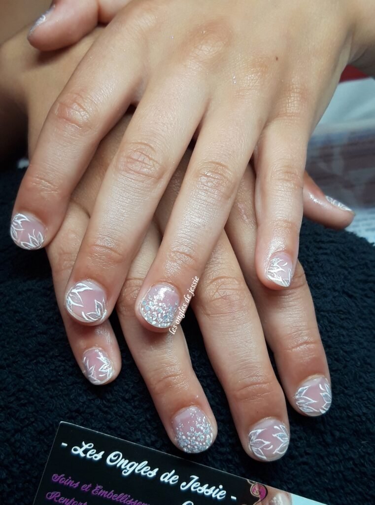 Décoration délicate réalisée à la main sur les ongles d’une jeune fille